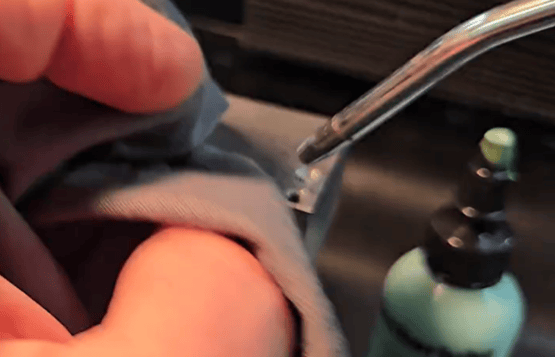 Compressed air gun and shop rag blowing chips from a broken tap prior to Omega Drill use
