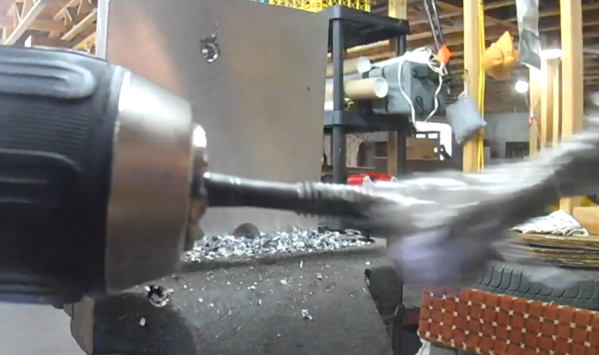 Applying DIY tapping fluid to drill bit using anti-seize applicator brush.