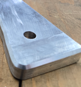 Indexable pneumatic chamfering tool in use on metalwork piece.