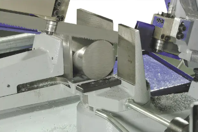 Band saw cutting a round metal workpiece