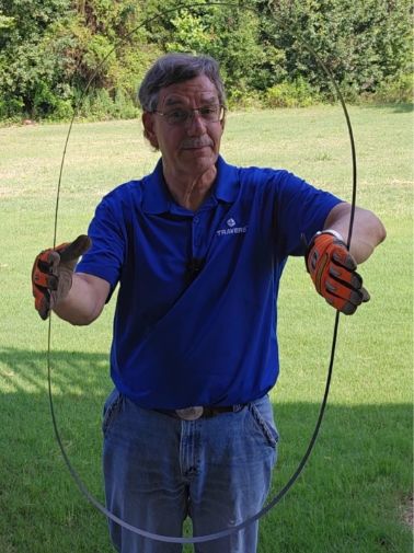 Kurt holding a band saw blade vertically with both hands
