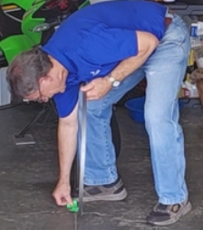 Place the blade upright on the floor with one foot on it