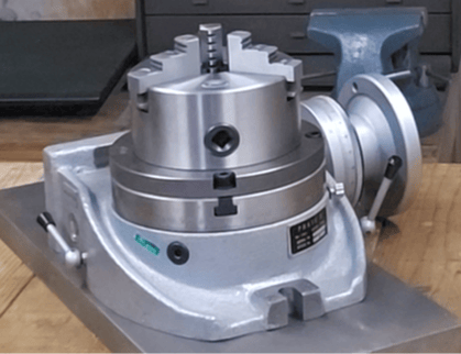 Rotary table with adapter plate and lathe chuck mounted for precision machining