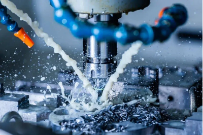 Milling cutter machining a metal workpiece with coolant